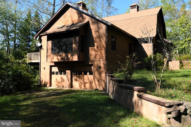 view of home's exterior featuring a lawn and a garage