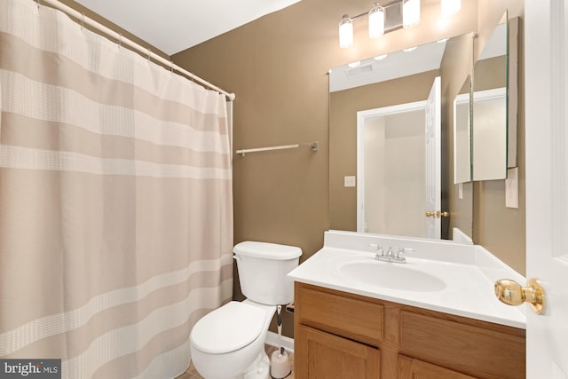 bathroom featuring vanity, toilet, and a shower with shower curtain