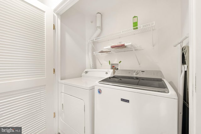 clothes washing area featuring separate washer and dryer