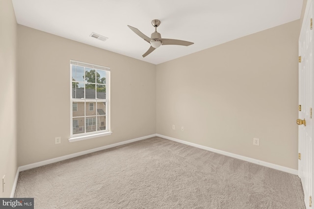 spare room featuring ceiling fan and carpet