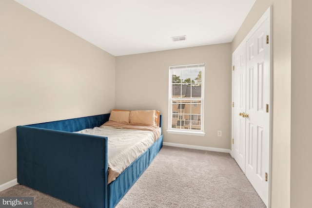 carpeted bedroom featuring a closet