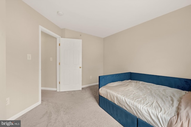 carpeted bedroom featuring lofted ceiling