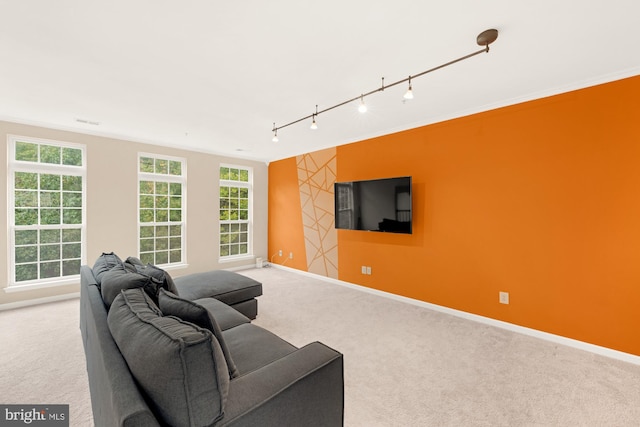 living room featuring ornamental molding, light colored carpet, and track lighting