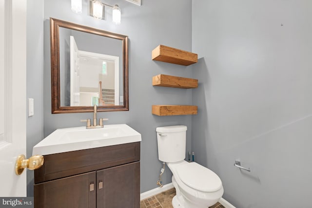 bathroom featuring vanity and toilet