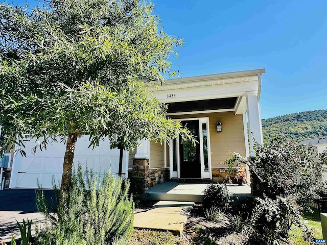 view of exterior entry with a garage