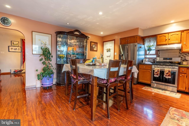 dining space with dark hardwood / wood-style flooring