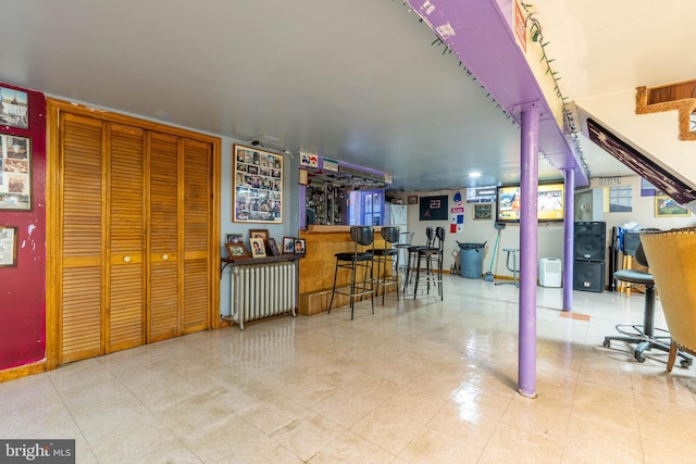 interior space featuring bar area and radiator