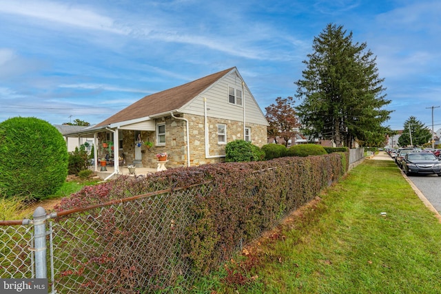 view of property exterior with a yard