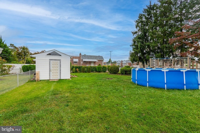 view of yard featuring a shed and a fenced in pool