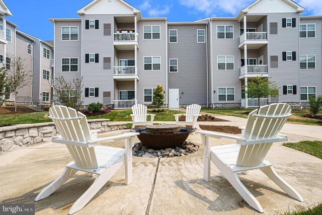 exterior space with a balcony and a fire pit