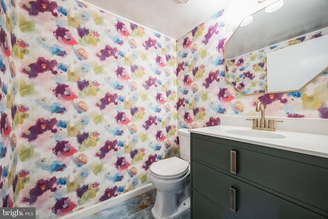 full bathroom featuring curtained shower, vanity, toilet, and wallpapered walls