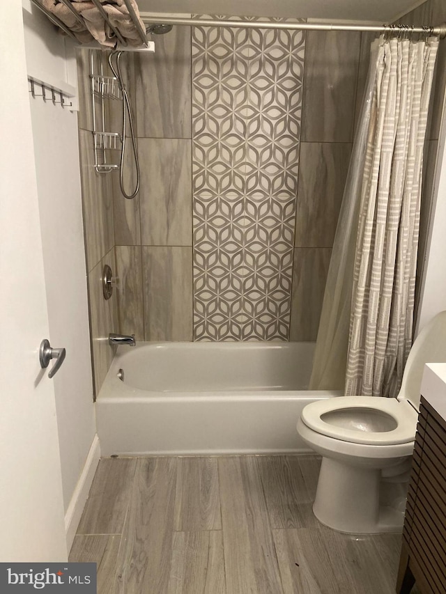 full bathroom featuring vanity, shower / tub combo, hardwood / wood-style flooring, and toilet