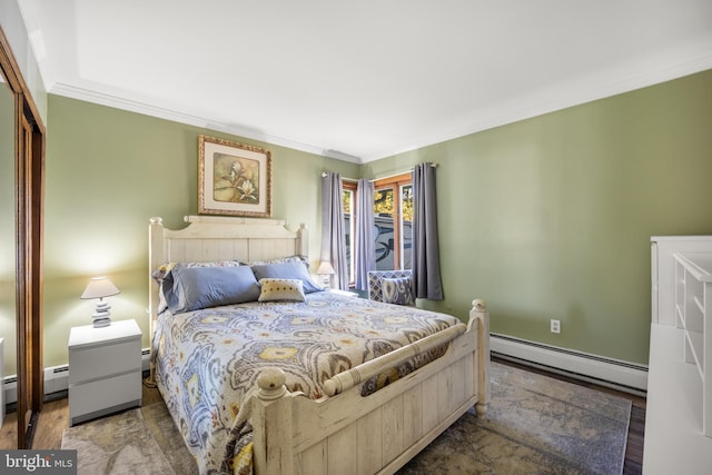 bedroom with a baseboard radiator, crown molding, wood-type flooring, and a closet