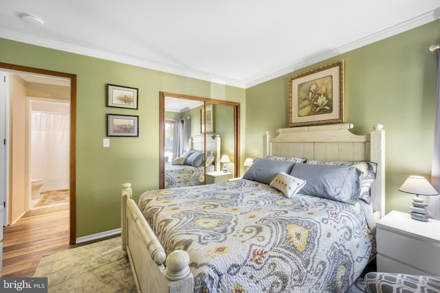 bedroom featuring light hardwood / wood-style floors, a closet, and ornamental molding