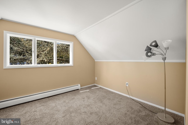 additional living space with baseboard heating, lofted ceiling, and carpet