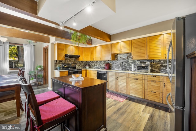 kitchen featuring hardwood / wood-style floors, sink, black appliances, rail lighting, and tasteful backsplash