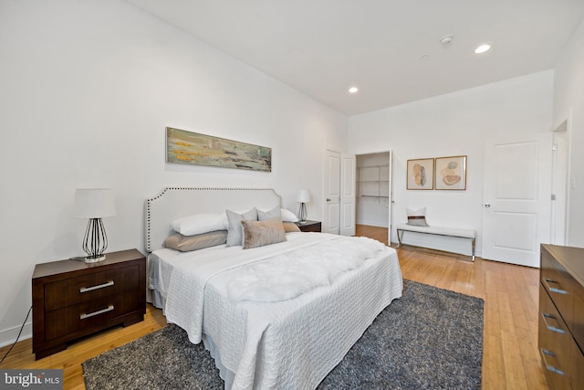 bedroom with light wood-type flooring and a closet