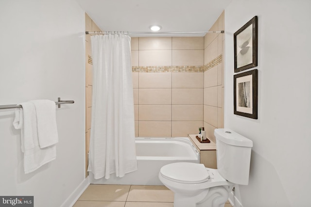bathroom with toilet, shower / bath combo, baseboards, and tile patterned flooring