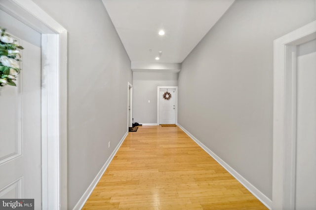 hall featuring recessed lighting, light wood finished floors, and baseboards