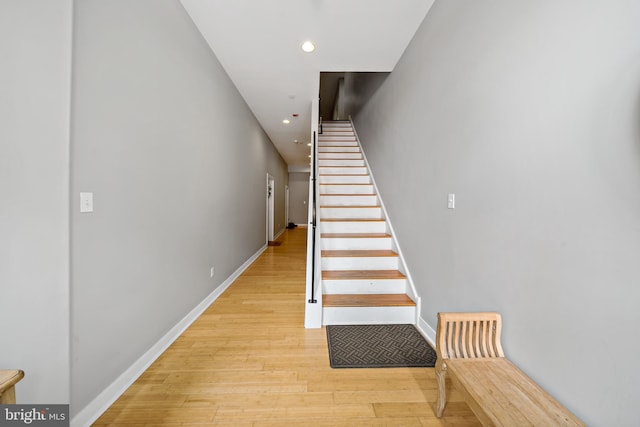 staircase with hardwood / wood-style floors