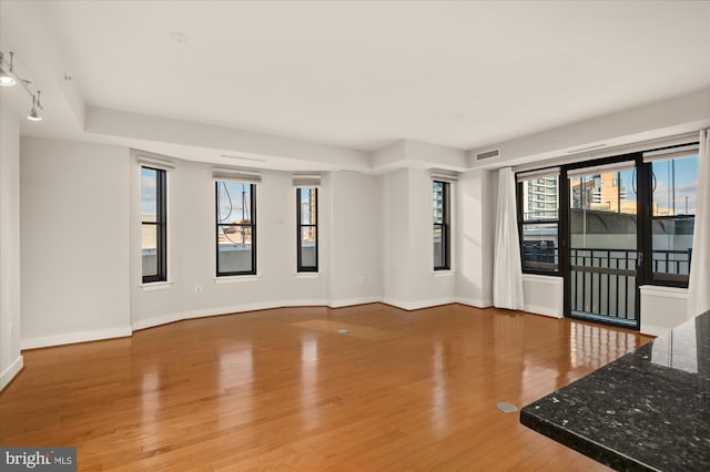 unfurnished living room with wood-type flooring