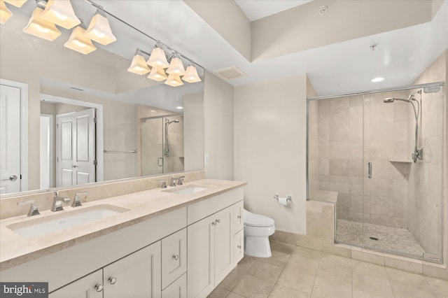 bathroom with vanity, a shower with shower door, tile patterned floors, and toilet