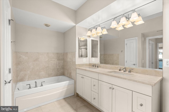 bathroom with tile patterned flooring, vanity, and a bathtub