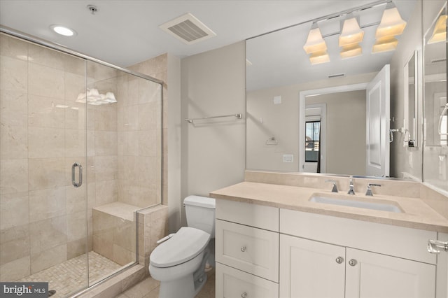 bathroom with vanity, tile patterned flooring, a shower with door, and toilet