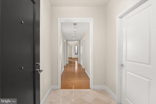 hallway featuring light tile patterned floors