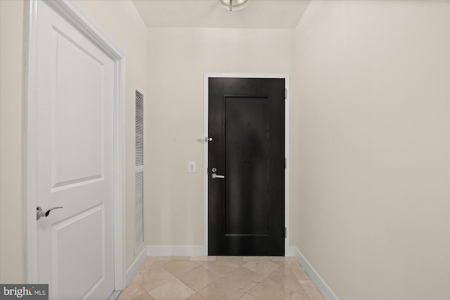 doorway to outside featuring light tile patterned flooring