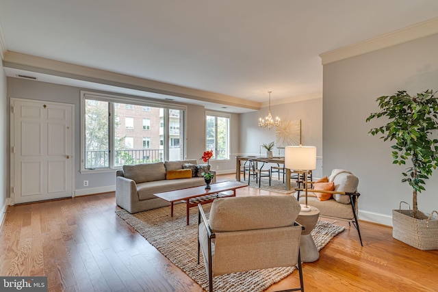 living room featuring crown molding, a chandelier, and light hardwood / wood-style flooring