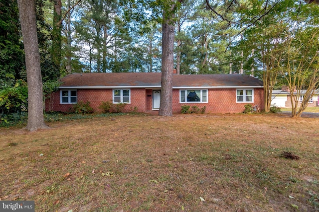 ranch-style home with a front lawn