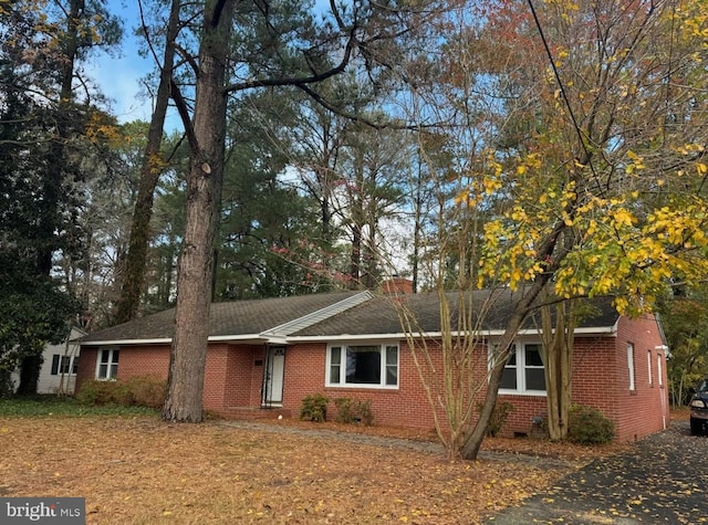 single story home featuring brick siding