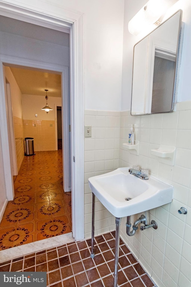 bathroom featuring tile walls, tile patterned floors, and wainscoting