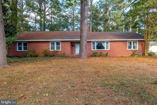 ranch-style home with a front lawn