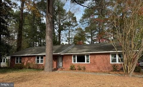 single story home featuring a chimney