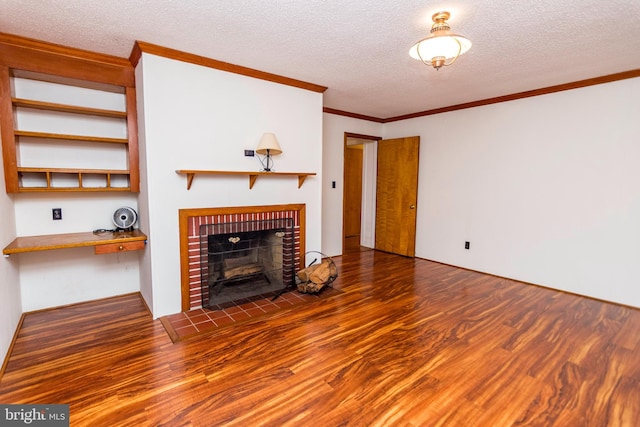 unfurnished living room with hardwood / wood-style floors, a textured ceiling, crown molding, a fireplace, and built in desk