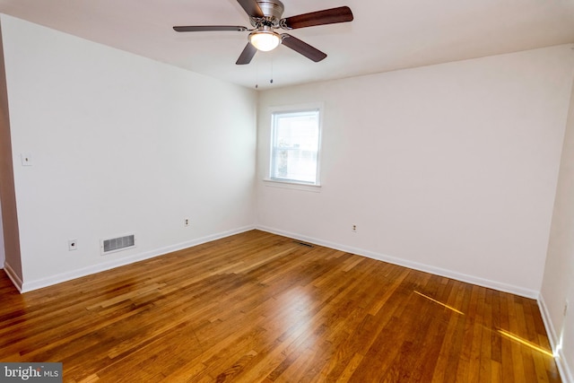 spare room featuring hardwood / wood-style floors and ceiling fan