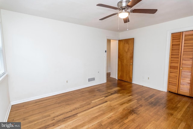 unfurnished bedroom featuring hardwood / wood-style floors and ceiling fan