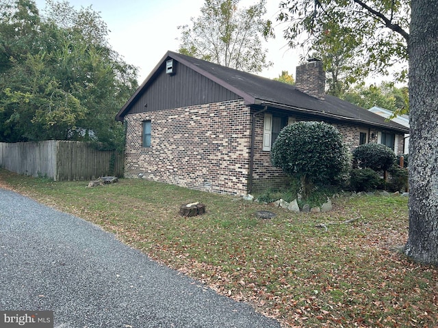 view of side of home with a yard