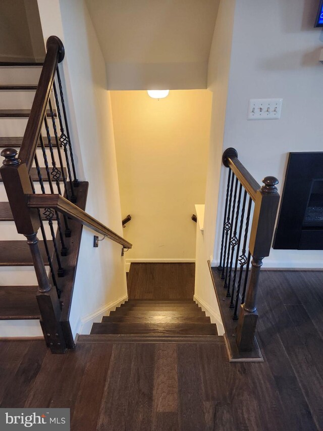 stairs featuring wood-type flooring