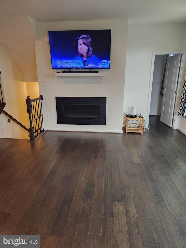 unfurnished living room featuring dark hardwood / wood-style floors