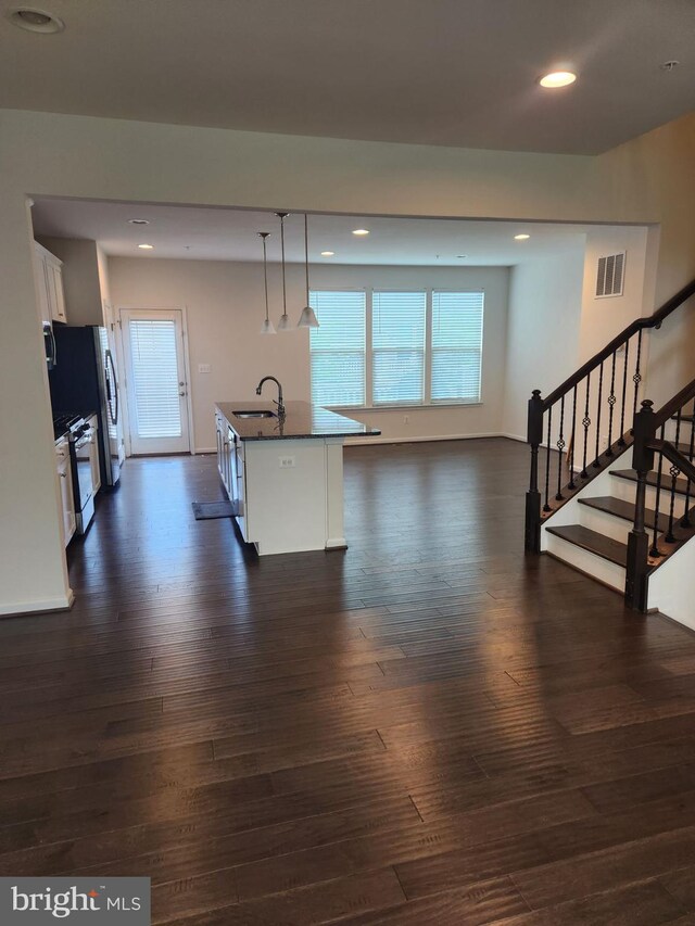 living room with sink and dark hardwood / wood-style flooring