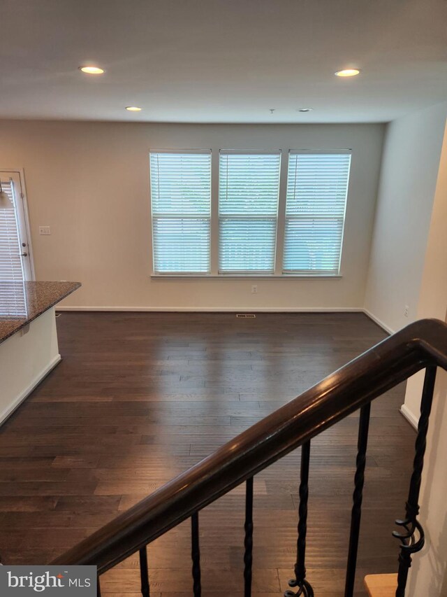 staircase with hardwood / wood-style flooring