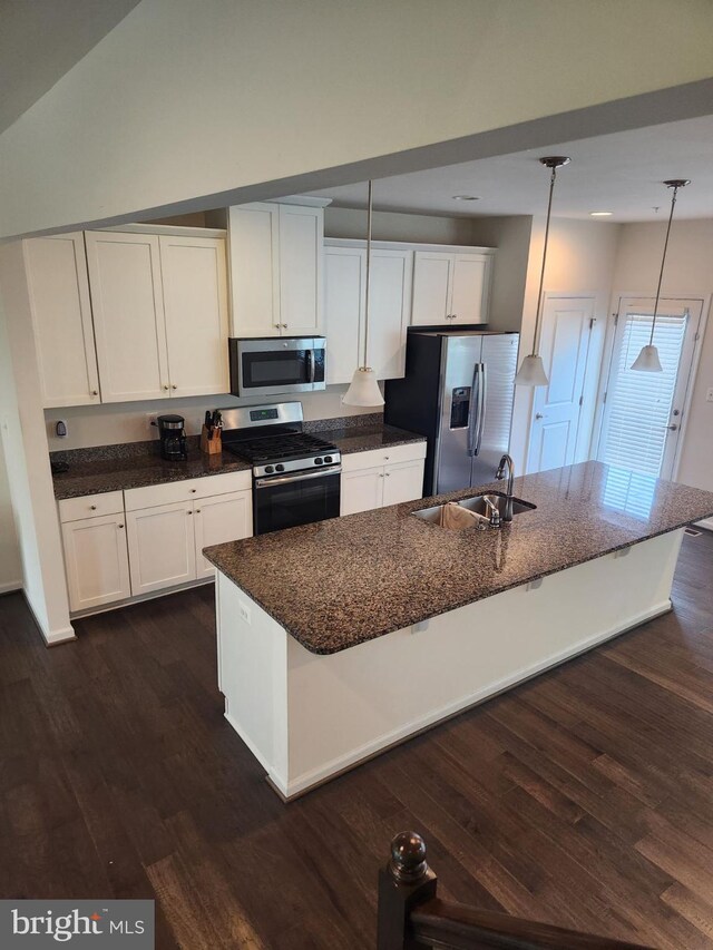 kitchen with stainless steel appliances, hanging light fixtures, dark hardwood / wood-style flooring, and white cabinetry