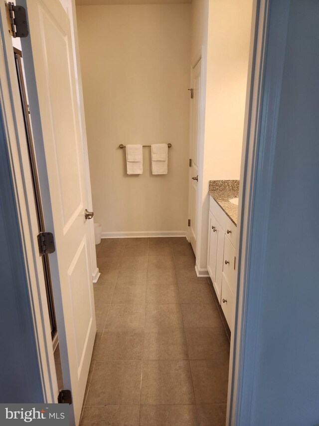 bathroom with tile patterned flooring and vanity