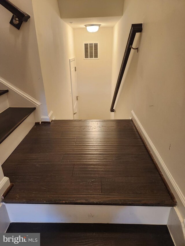 stairway with hardwood / wood-style floors