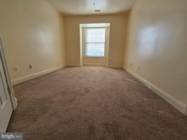 unfurnished room featuring light colored carpet