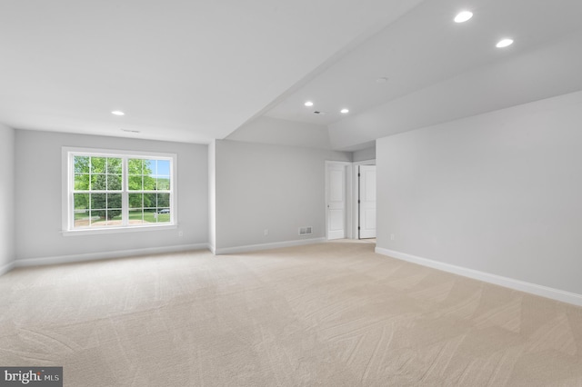 empty room with recessed lighting, light carpet, visible vents, and baseboards