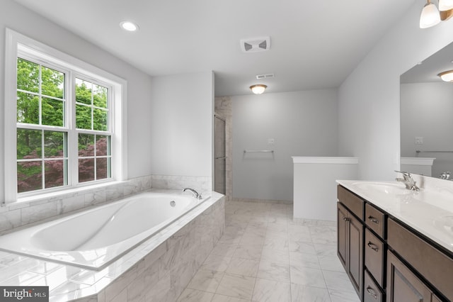 full bath with visible vents, tiled shower, vanity, and a bath